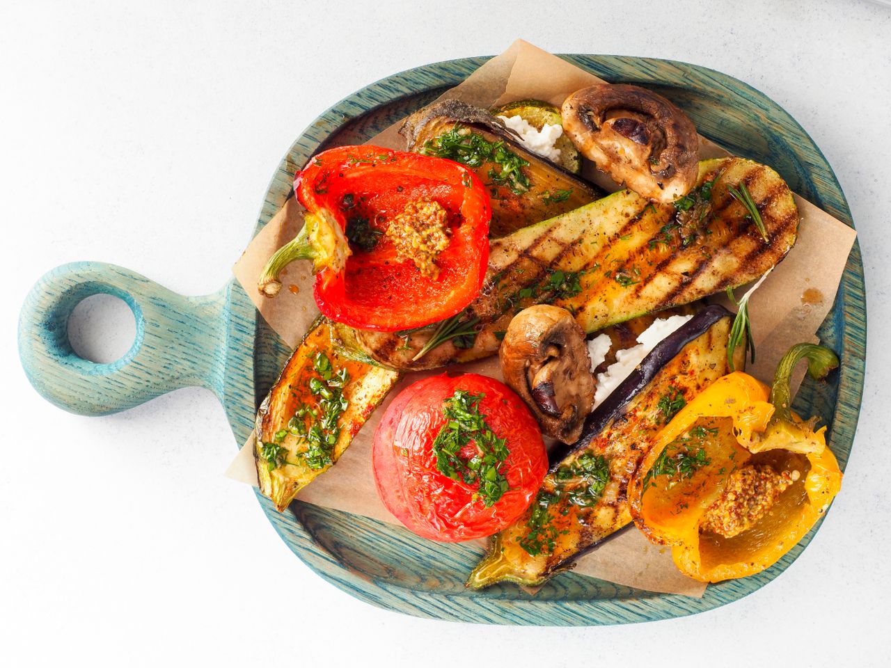 The Art of Drawing Readers In: Your attractive post title goes here A colorful assortment of grilled vegetables on a wooden board, captured from above.