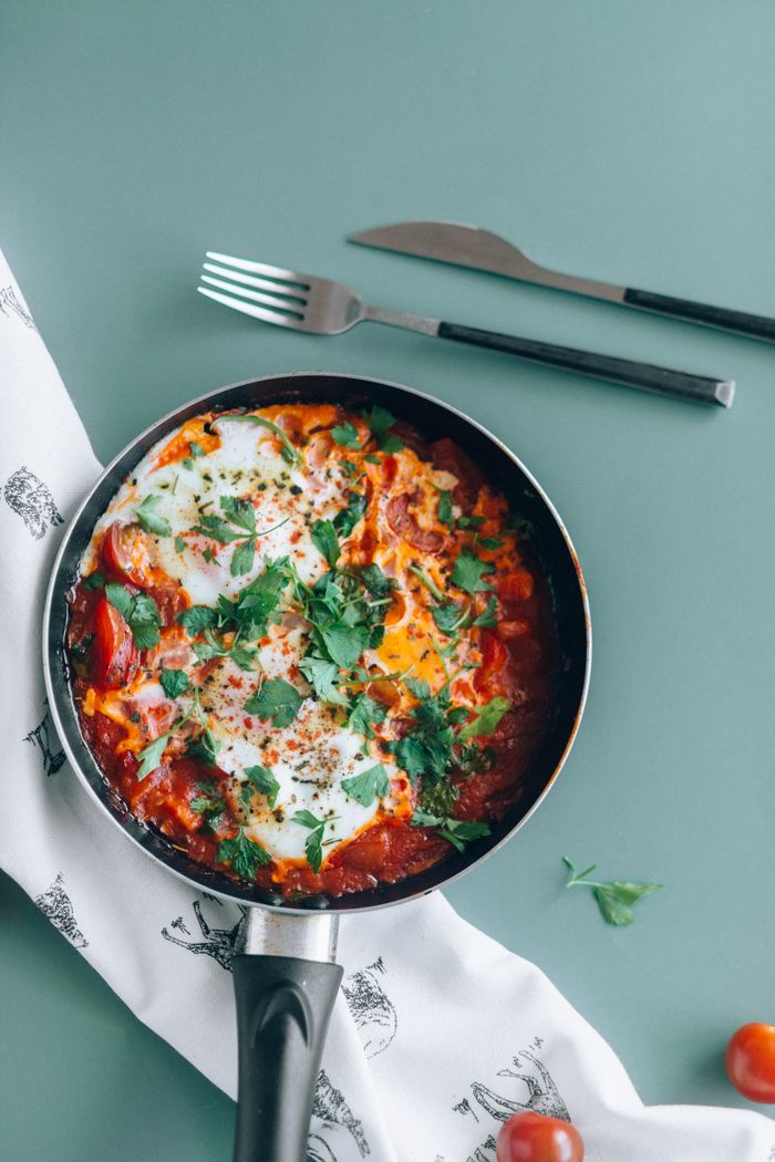 Crafting Captivating Headlines: Your awesome post title goes here Delicious shakshuka in a pan garnished with fresh parsley, perfect for a healthy meal.